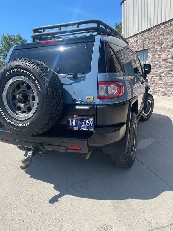 Rear view of a blue Toyota FJ Cruiser showing professional auto body repair and paint restoration at Plan B Auto Body.